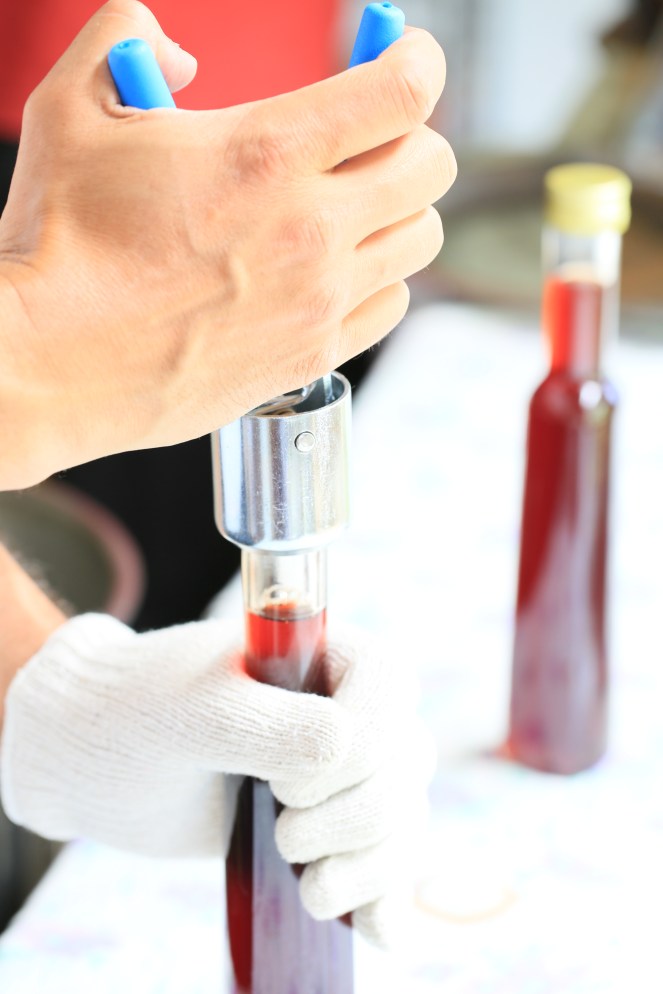 Hand sealing Ion Syrup bottles